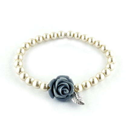 Pearl bracelet with a gray rose and silver leaf charm on a white background