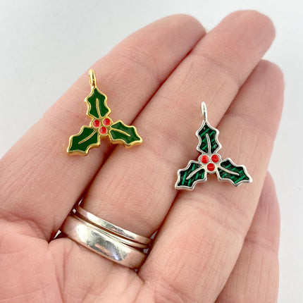 Enamel holly charms in hand